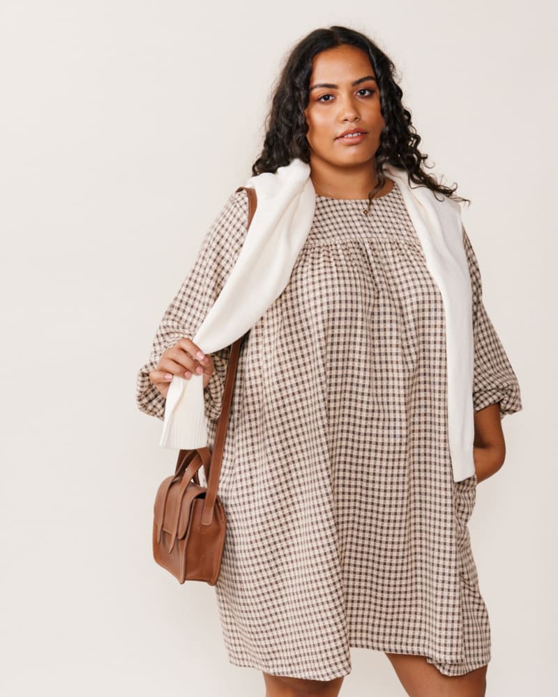 Front of a model wearing a size XXL Alyssa Mini Dress in Brown Gingham by ABLE. | dia_product_style_image_id:271521